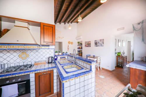 a kitchen with blue and white tiled counter tops at Agrodolce B&B in Cefalù