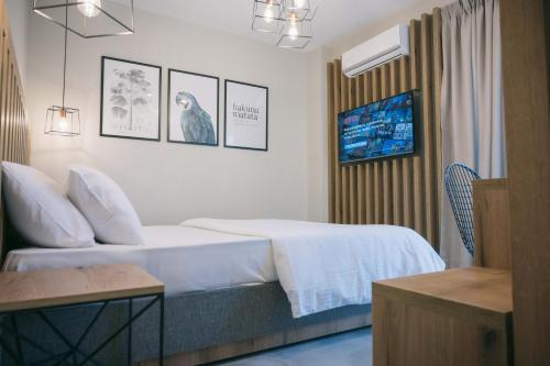 オリンピアキ・アクティにあるHotel Hermes Pieriaのホテルルーム ベッド1台、壁に絵画が備わります。