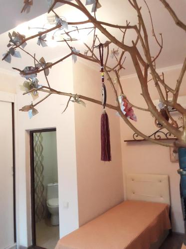 a tree branch with birds on it in a bathroom at Batumi Wonderland in Batumi