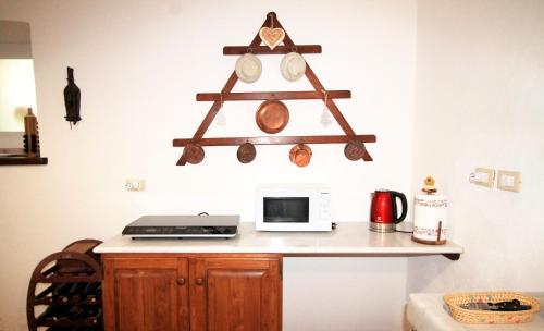 a kitchen with a counter with a laptop and a microwave at Ca' du Tu in Masone