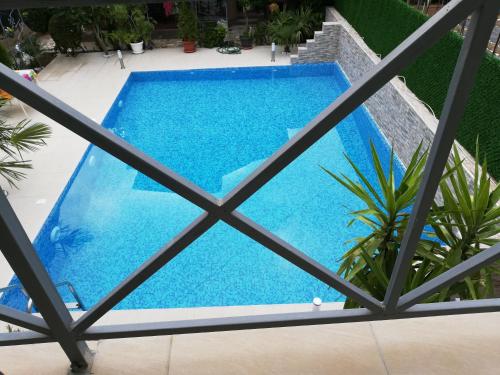 a swimming pool seen through the window of a building at Lile Pestani Accommodation in Peštani