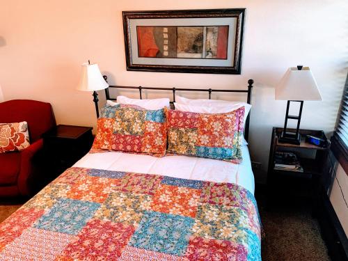 a bedroom with a bed with a quilt and pillows at Iowa House Historic Inn in Ames