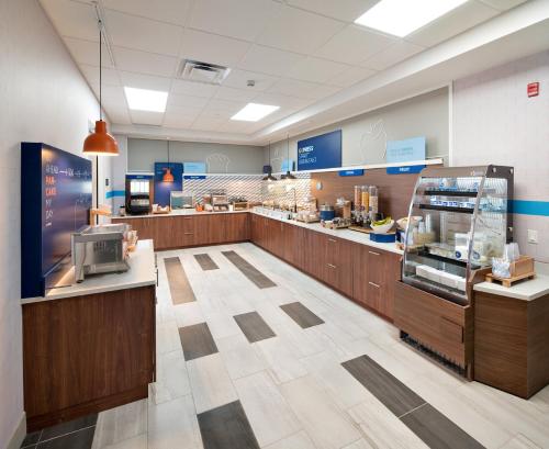 a fast food restaurant with a cash register and a counter at Holiday Inn Express - Red Deer North by IHG in Red Deer