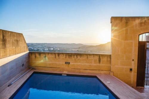 a large swimming pool on top of a building at Ta Marija in Żebbuġ