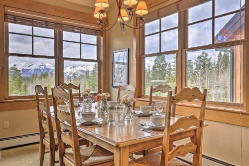 a dining room with a table and chairs and windows at Keystone Condo on Golf Course with Mountain View in Keystone