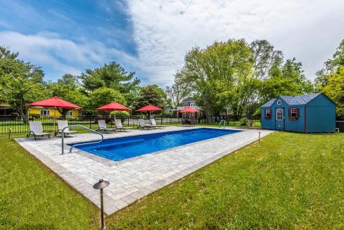 a swimming pool in a yard with a house at The Homestead B&B in Rehoboth Beach