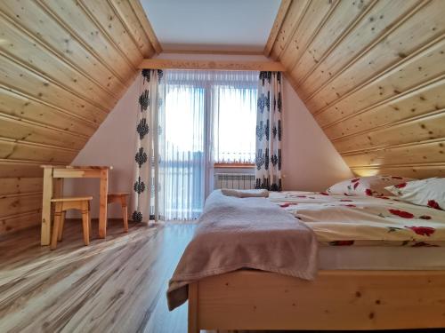 Tempat tidur dalam kamar di Pokoje Gościnne Kurosik