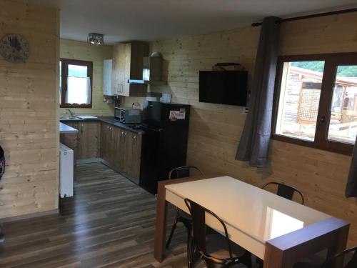 a kitchen with a table and chairs in a room at Casute la munte in Râşnov