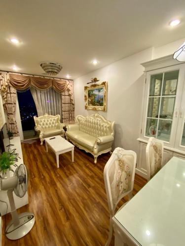 a living room with two chairs and a couch at SHP Plaza Khanh Phong Homestay in Hai Phong