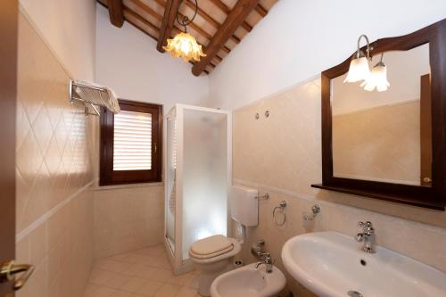a bathroom with a sink and a toilet and a mirror at Casa Vacanze S. Marco in Valderice