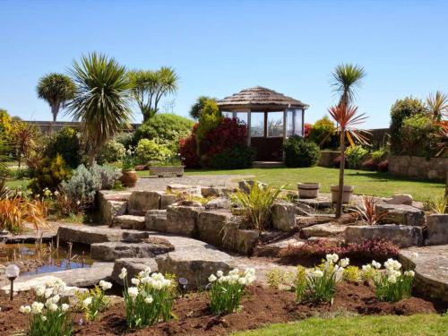 a garden with a gazebo in the background at Bournemouth Carlton Hotel, BW Signature Collection in Bournemouth