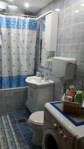 a bathroom with a toilet and a sink at Apartman Lux K in Bijeljina