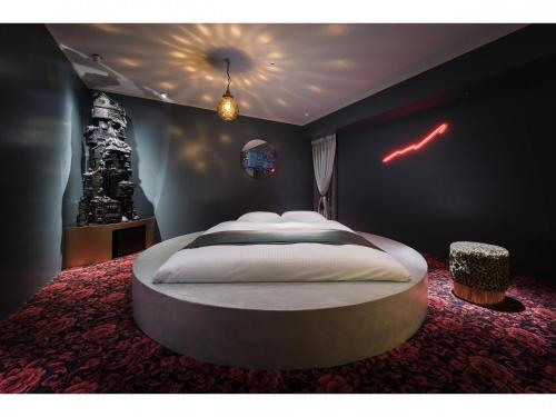 a bedroom with a large white bed in it at BnA Alter Museum in Kyoto