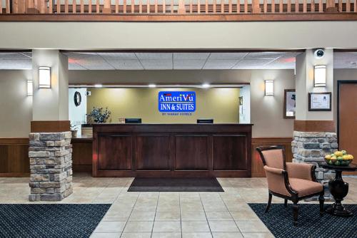 a lobby with a waiting area with a sign that reads attack of anesthesia at AmeriVu Inn and Suites - Waconia in Waconia
