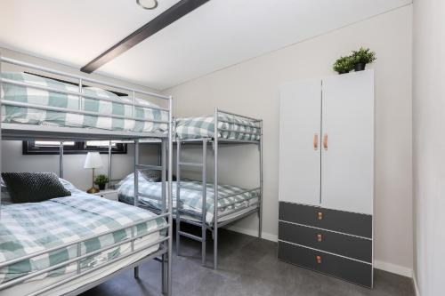 a bedroom with two bunk beds and a desk at Beach house in Erm