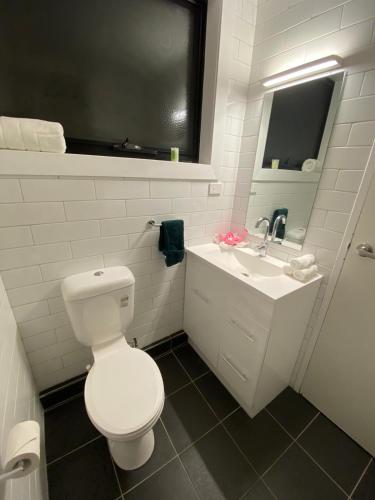 a white bathroom with a toilet and a sink at Cosy Apartment Tara Edelweiss at Skiing Resort of Falls Creek in Falls Creek