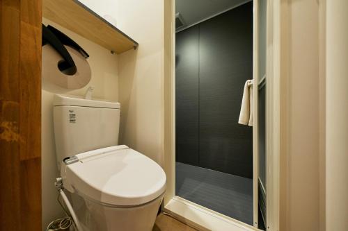 a small bathroom with a toilet and a shower at mizuka Imaizumi 2 - unmanned hotel - in Fukuoka