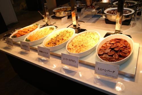 a buffet of different types of food on a counter at Nishiizu Crystal View Hotel in Nishiizu