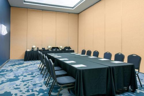 a conference room with a long table and chairs at Holiday Inn Melbourne-Viera Conference Ctr by IHG in Melbourne