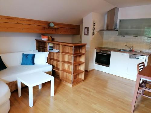 a living room with a couch and a table and a kitchen at Appartements Spielberg in Leogang