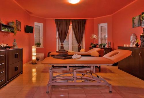 a living room with orange walls and a table at Aneta in Grzybowo