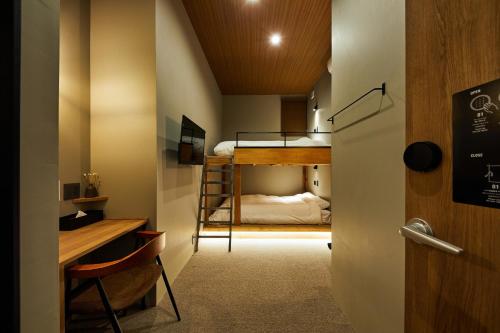 a small room with a bunk bed and a desk at mizuka Imaizumi 2 - unmanned hotel - in Fukuoka
