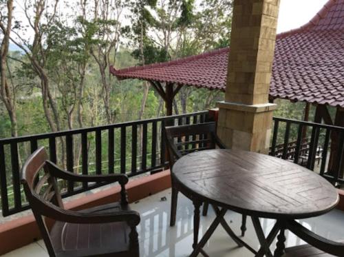a table and two chairs on a balcony at Bina Karya Guesthouse Syariah in Bantul