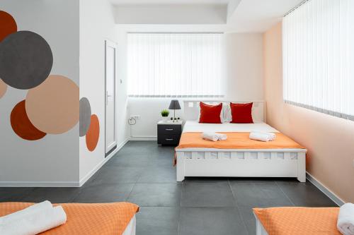 a bedroom with two beds with red pillows at Kostovski Rooms-near E75 to Greece in Veles