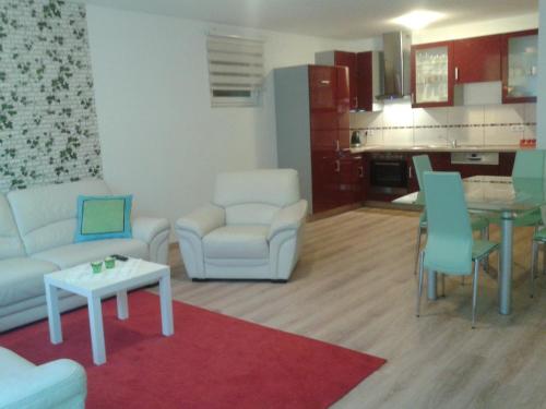 a living room with a couch and chairs and a table at Haus Senel in Eben im Pongau