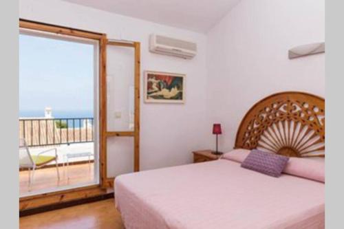 a bedroom with a large bed and a balcony at GRAN VISTA in Santa Pola