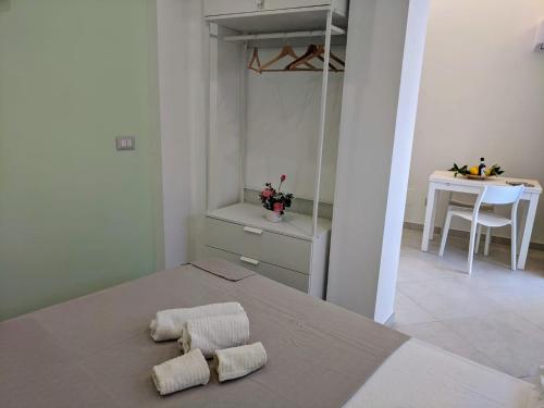 a bedroom with a bed with two towels on it at Punticello House in Procida