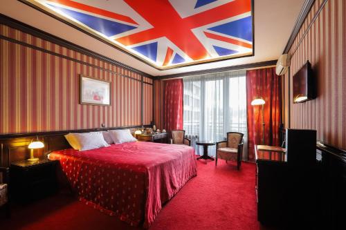 a hotel room with a bed with a red blanket at Attache Hotel in Kyiv