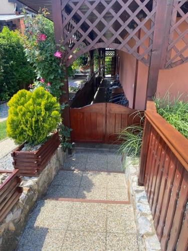 a walkway with a wooden fence and some plants at Holiday Home V Kolte in Kolta