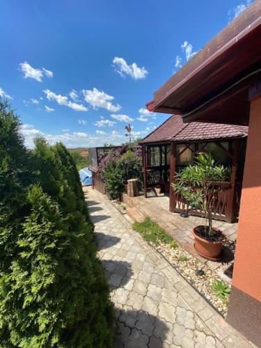 a walkway next to a building with a pavilion at Holiday Home V Kolte in Kolta