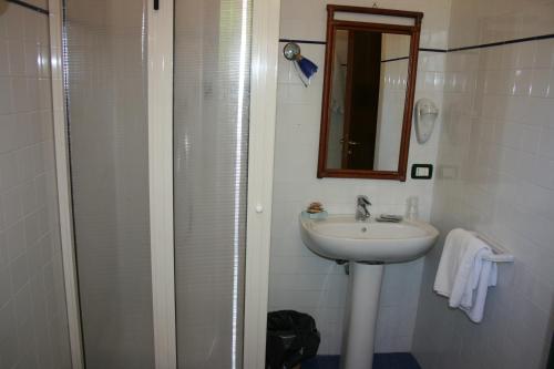 a bathroom with a sink and a shower with a mirror at casa vacanze marzano in Tropea