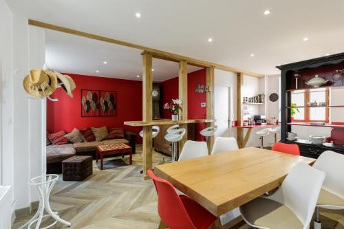 a kitchen and living room with a wooden table and chairs at mon château en Berry in Les Aix-dʼAngillon