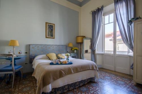 a bedroom with a bed and a table with fruit on it at Il Sole Antico in Viareggio