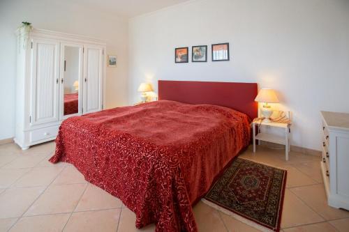 アーデナウにあるVilla Eifelpalace am Nürburgringの赤いベッド1台(赤い毛布付)が備わるベッドルーム1室が備わります。