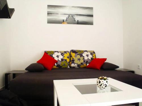 a couch with pillows and a table in a room at Apartment Ella in Split