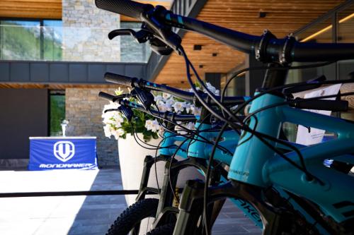 a bike parked in front of a building with flowers at Hotel La Vetta in San Domenico