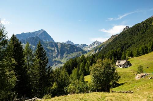 a valley in the mountains with a house on a hill at Hotel La Vetta in San Domenico