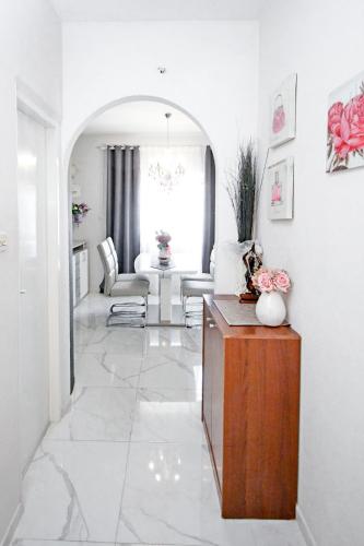 a white living room with a table and a living room at Villa Norah in Podgora