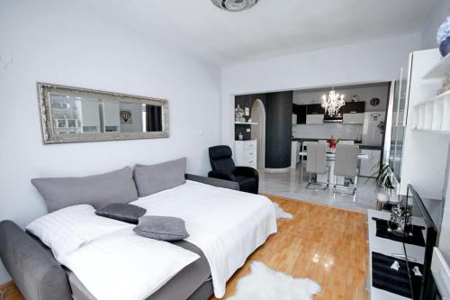 a bedroom with a bed and a living room at Villa Norah in Podgora