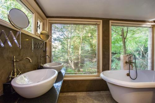 a bathroom with two sinks and a large window at Garmen Hills Guest Houses in Garmen