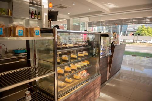 a bakery with a display case filled with donuts at Baan Suan Khun Ta and Golf Resort in Ubon Ratchathani