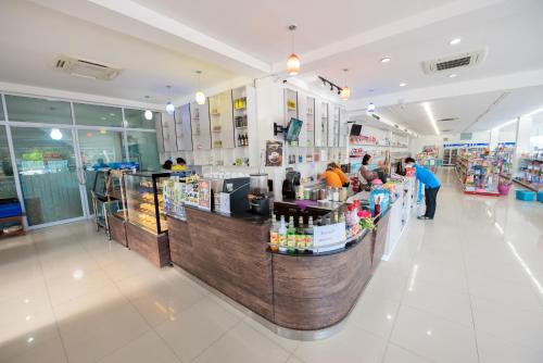 a store aisle with a counter in a grocery store at Baan Suan Khun Ta and Golf Resort in Ubon Ratchathani