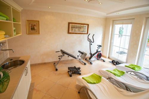 a room with a gym with two exercise bikes at Villa Eifelpalace am Nürburgring in Adenau