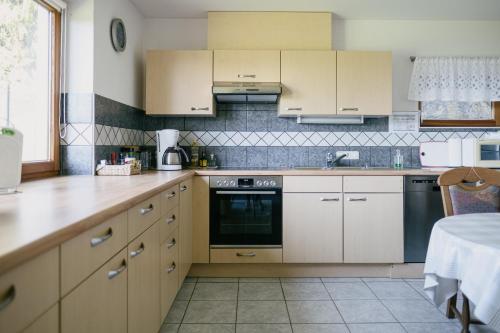 a kitchen with white cabinets and a counter top at FeWo Ruhe in Hohenems