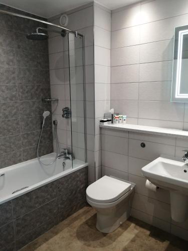 a bathroom with a shower and a toilet and a sink at Best Western Plus Angel Hotel in Chippenham