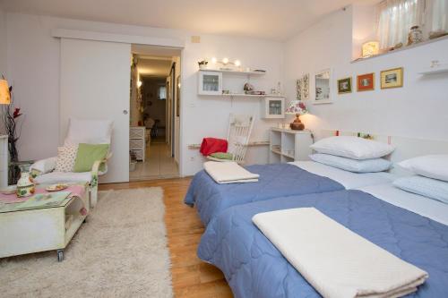 a bedroom with two beds and a living room at Apartment Nena in Split